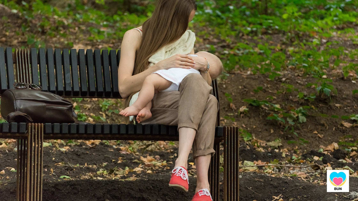 woman breastfeeding in public outdoors