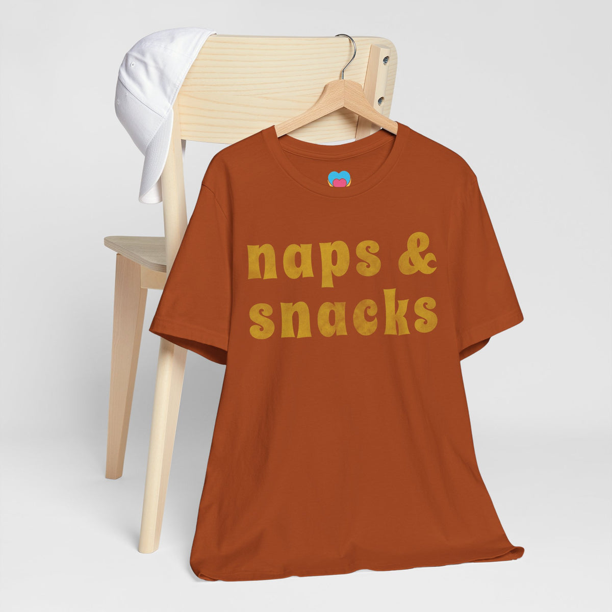 naps and snacks tee shirt autumn color on clothes hanger