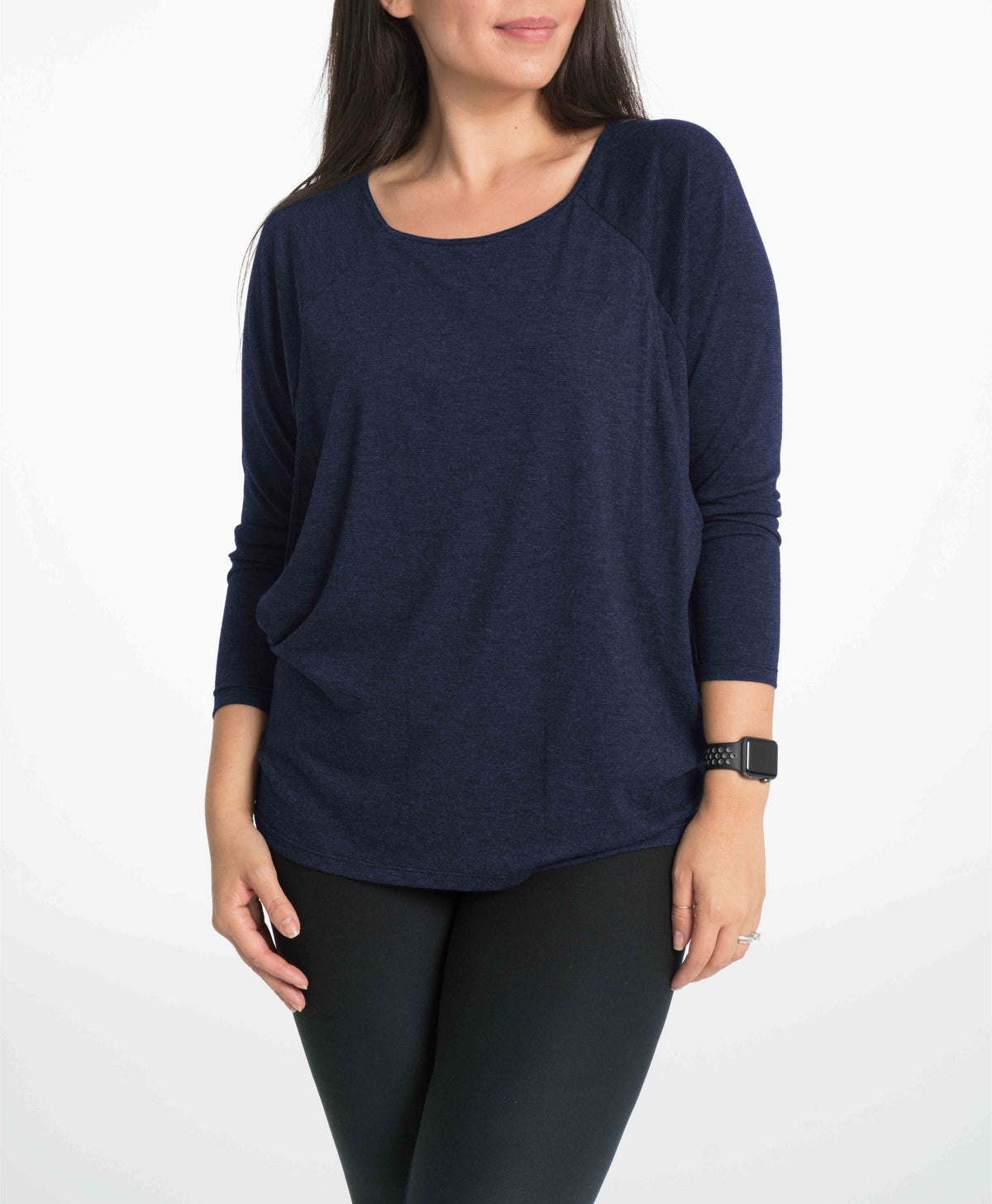 Woman wearing a navy blue nursing long sleeve top on a white background