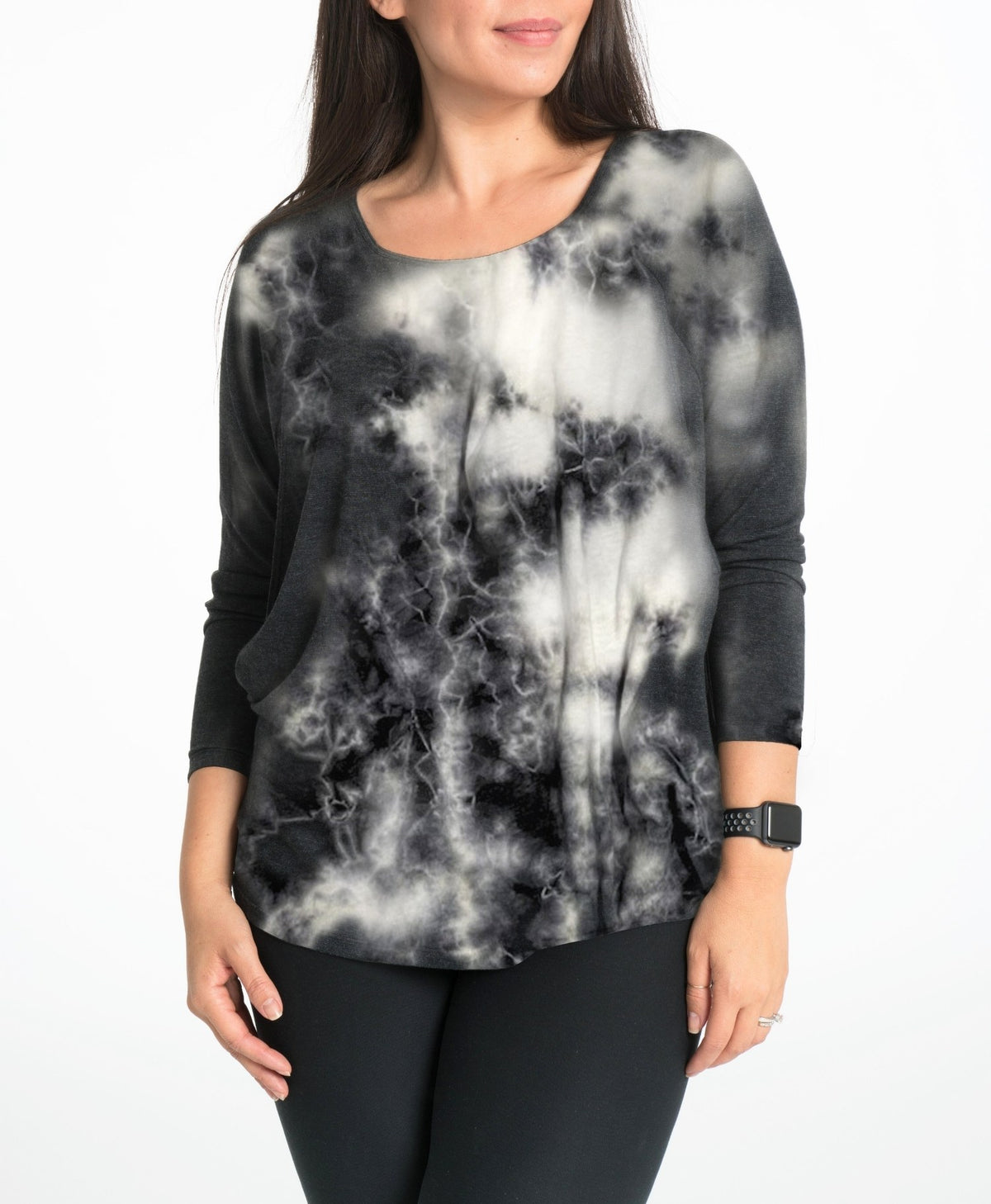 Woman wearing a black and white tie-dye nursing longsleeve top on a white background